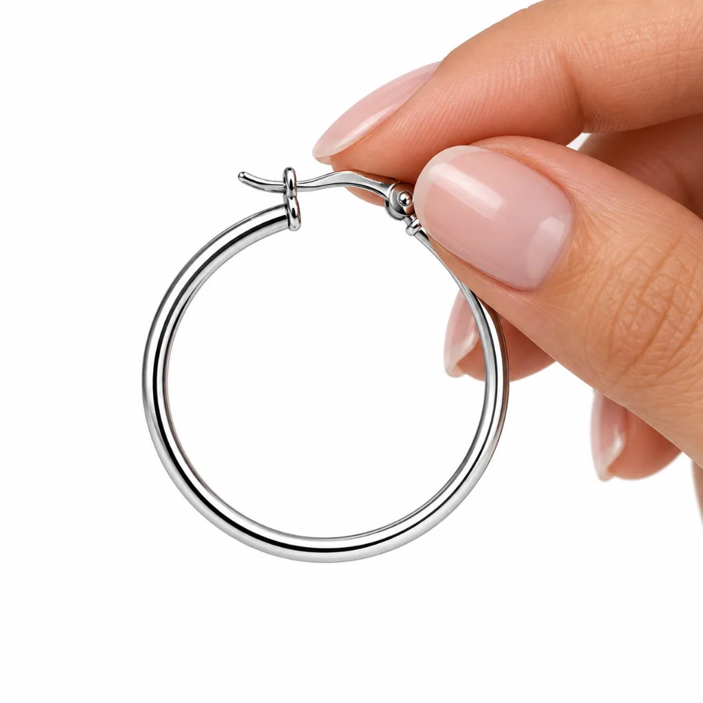 Side view of elegant sterling silver hoop earrings showcasing their slim design and polished surface.