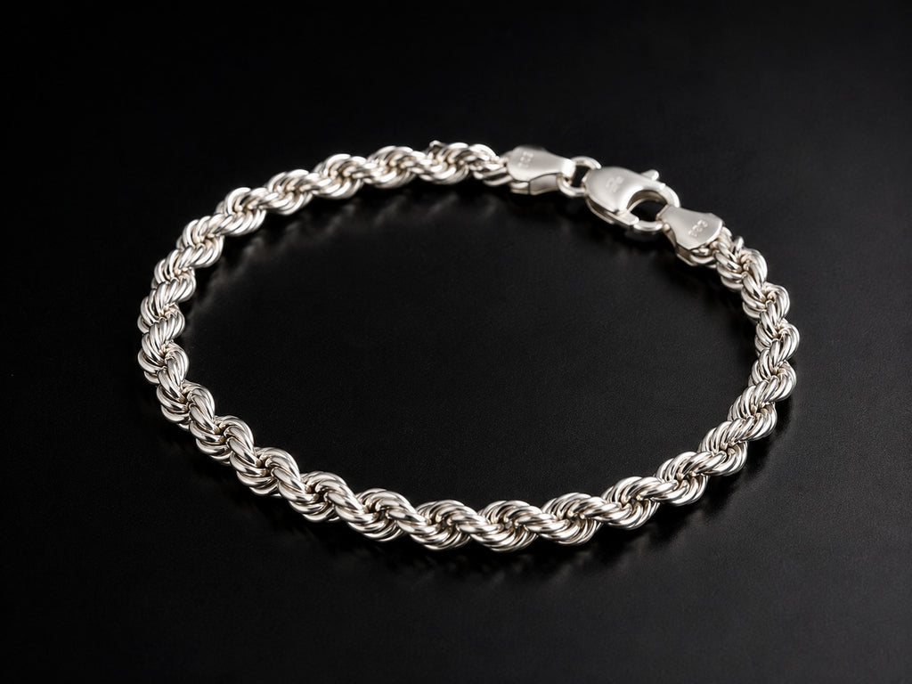 A silver twisted rope chain bracelet with a lobster clasp, displayed on a dark black background.