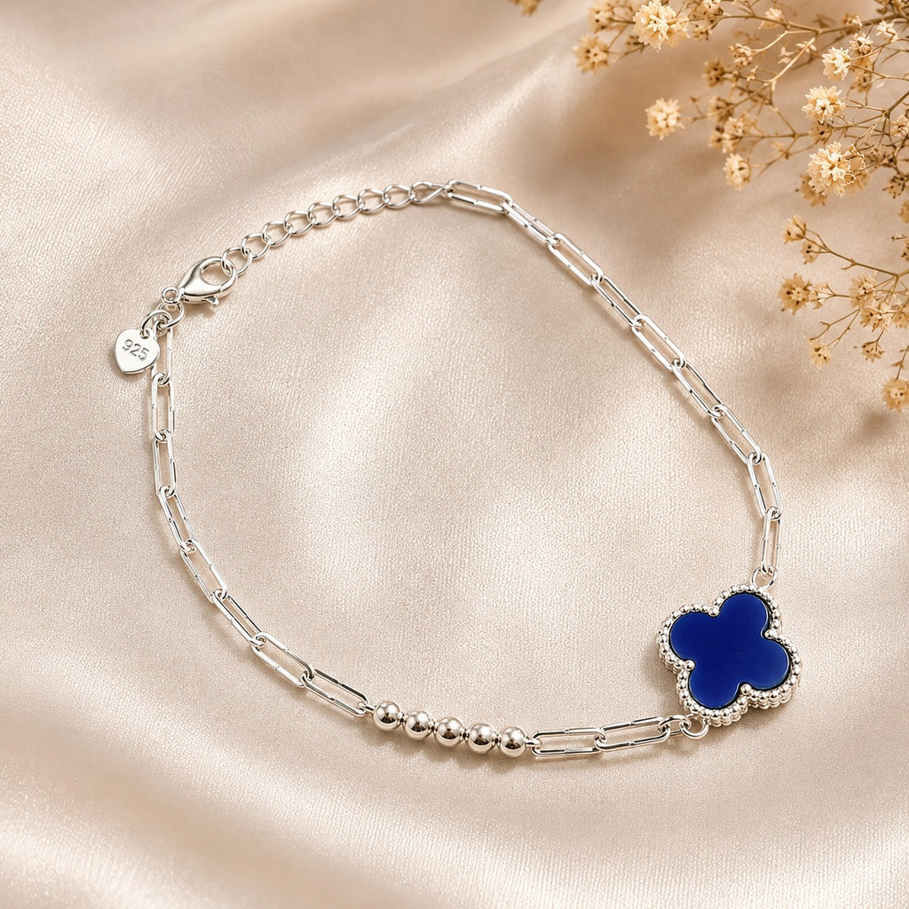 Adjustable sterling silver bracelet with elegant blue clover pendant