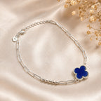 Adjustable sterling silver bracelet with elegant blue clover pendant