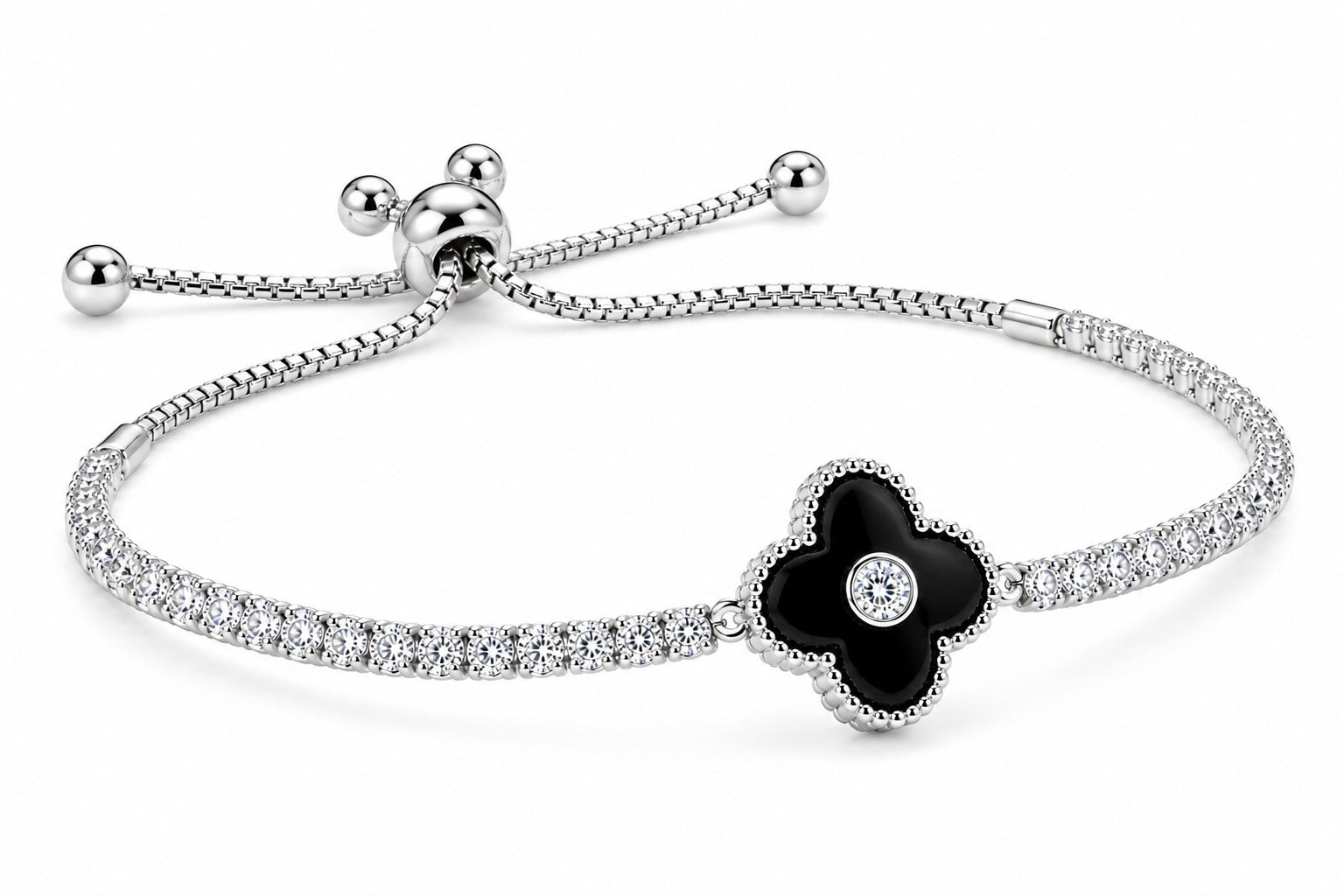 A silver-toned bracelet featuring a four-petal flower centerpiece with a black enamel center and a small clear stone, set on a pavé-set silver band with an adjustable sliding closure.
