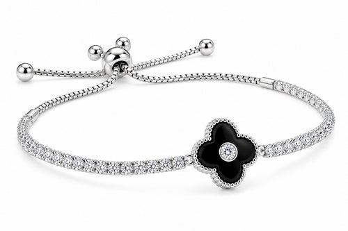 A silver-toned bracelet featuring a four-petal flower centerpiece with a black enamel center and a small clear stone, set on a pavé-set silver band with an adjustable sliding closure.