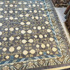 Close-up of the blue, cream, and beige geometric border on an Afghan hand-knotted wool rug.