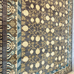 Large Afghan handmade wool rug with cream pomegranate motifs and intricate blue and beige borders.