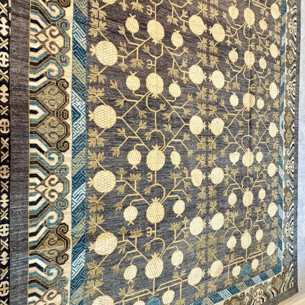 Large Afghan handmade wool rug with cream pomegranate motifs and intricate blue and beige borders.