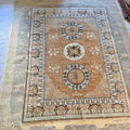 Detailed view of a traditional medallion motif on a tan and light blue Afghan Khotan-inspired wool rug.