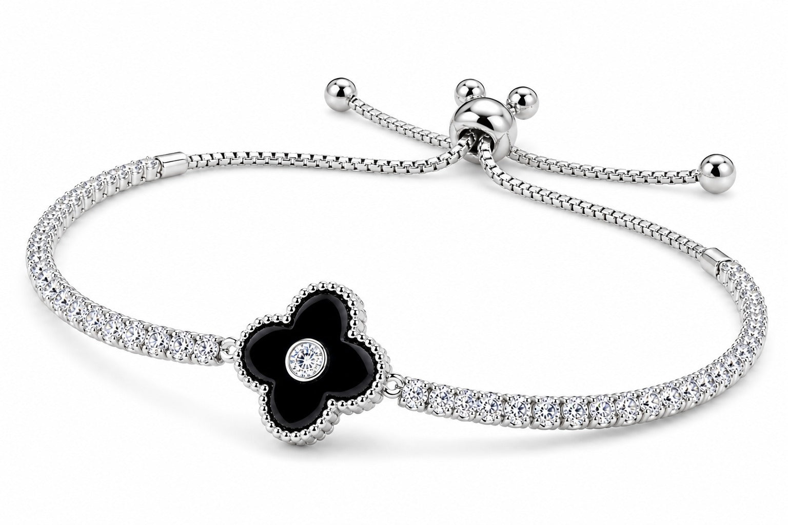 A silver-toned adjustable bracelet featuring a black enamel flower charm with a small clear stone in the center, set against a plain white background.