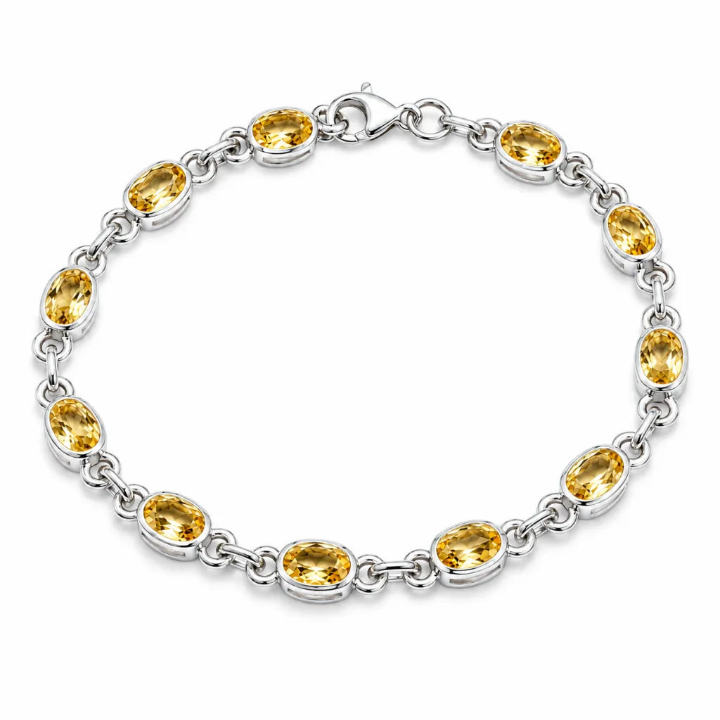 Silver citrine link bracelet with twelve oval bezel-set golden yellow gemstones and lobster clasp