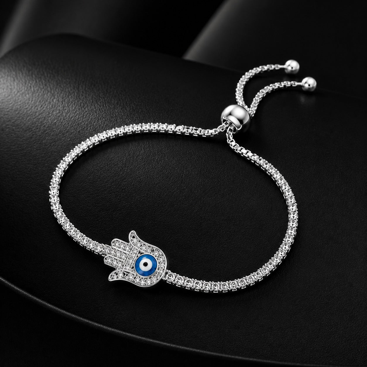 Close-up of CZ Hamsa evil eye charm on sterling silver bracelet