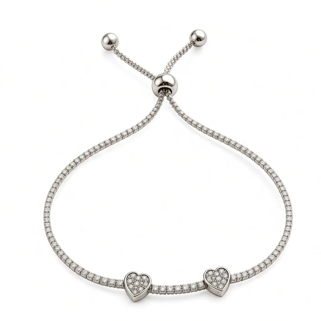 Silver double heart tennis bracelet with two pavé heart charms, cubic zirconia stones and adjustable slider closure