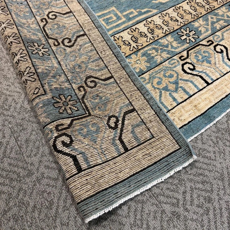 Handmade blue and beige wool rug for traditional home decor
