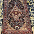 5.2 x 3.3 ft Kashmiri silk area rug with a traditional navy blue Persian-inspired medallion and multicolored floral design.