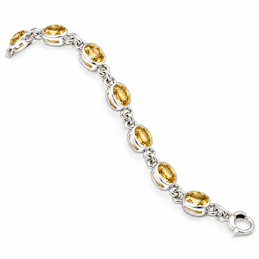Side view of silver oval citrine link bracelet with bezel-set yellow gemstones and spring ring clasp