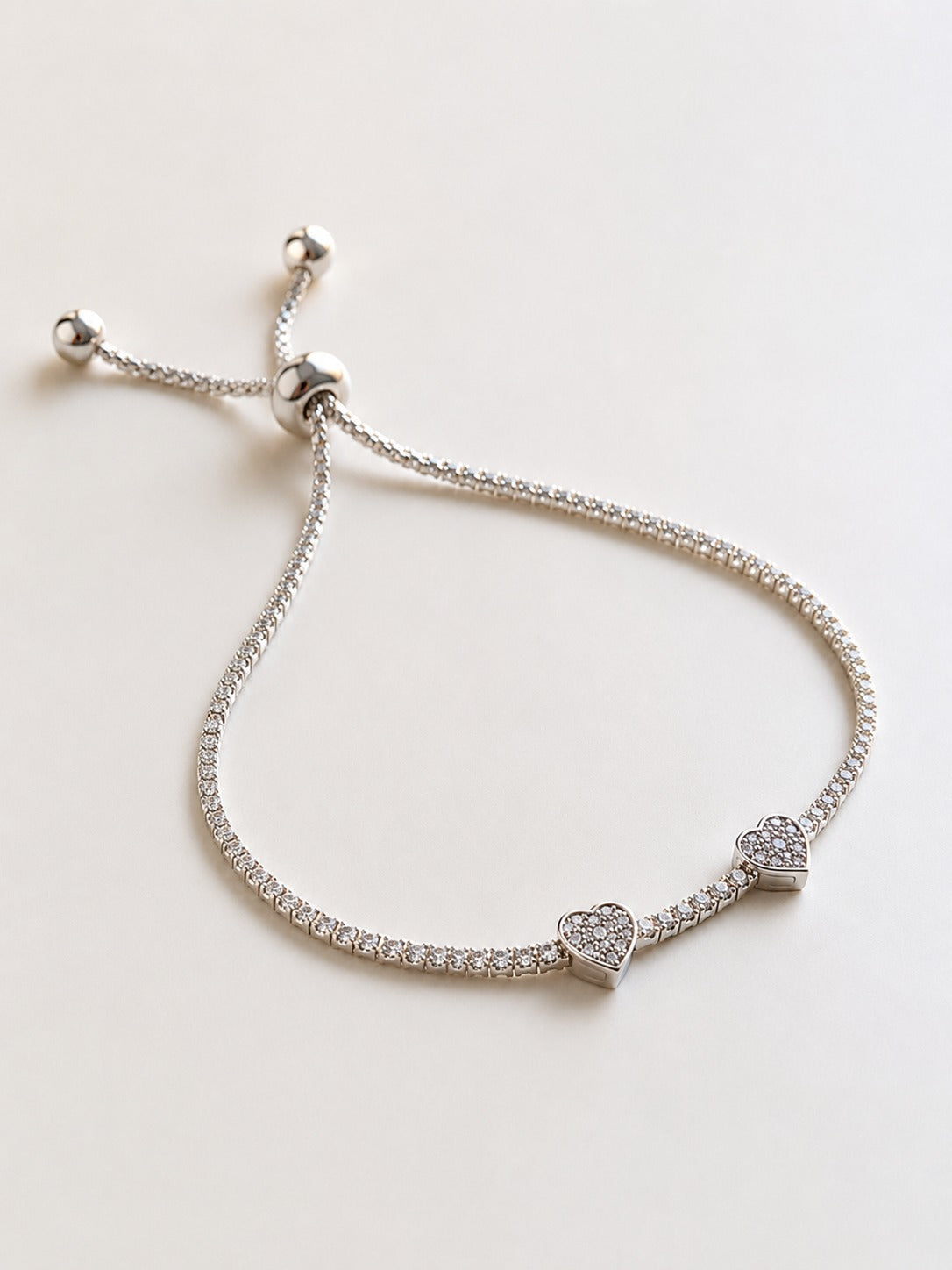 Elegant double heart sterling silver bracelet with sparkling crystal details