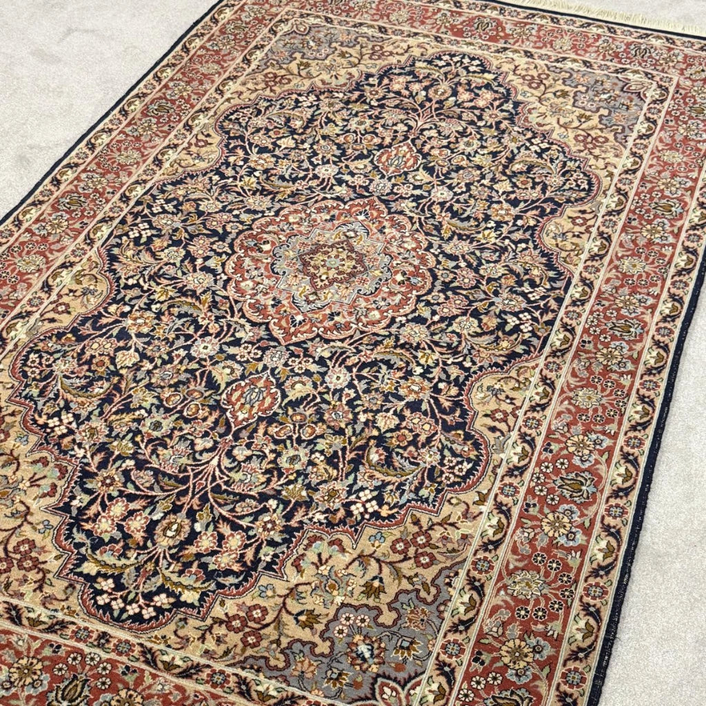 Vintage Tabriz-style Persian rug with navy blue floral medallion and rust red border