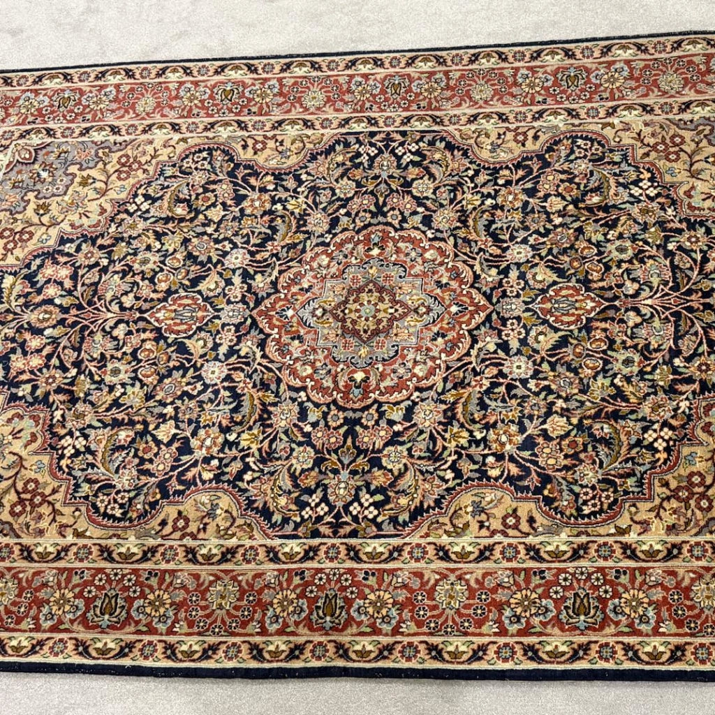 Traditional floral pattern and detailed borders on a vintage Tabriz-style Persian area rug