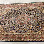 Traditional floral pattern and detailed borders on a vintage Tabriz-style Persian area rug